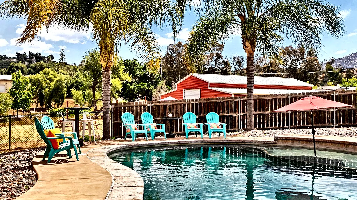 The pool and the barn at Red Barn Ranch, with the vineyard behind.