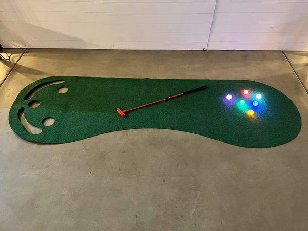 Glowing golf balls on the putting green.